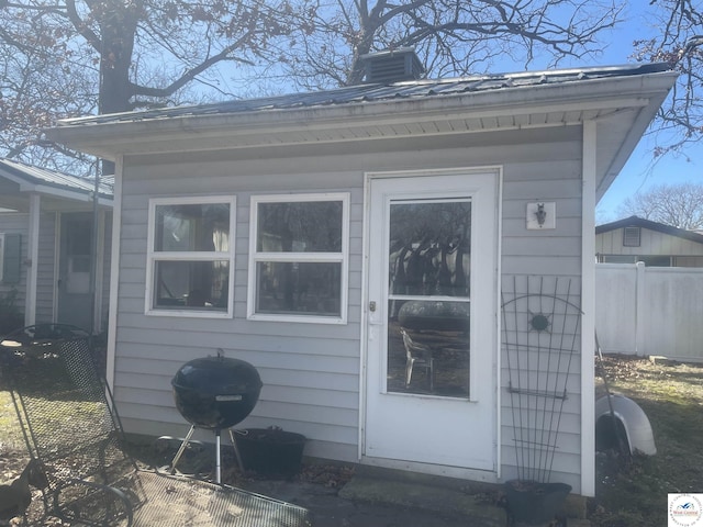 view of outbuilding featuring fence