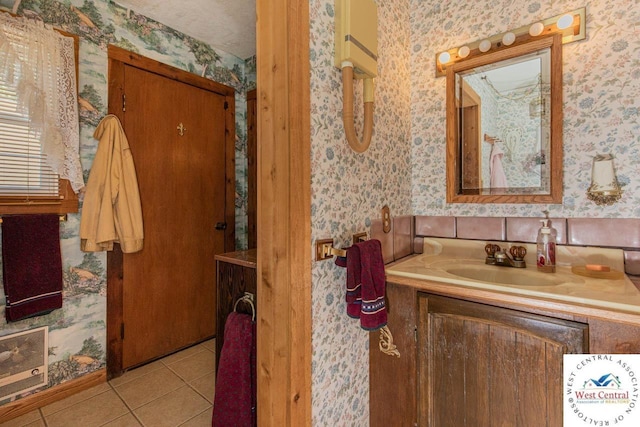 bathroom featuring heating unit, wallpapered walls, tile patterned flooring, and vanity