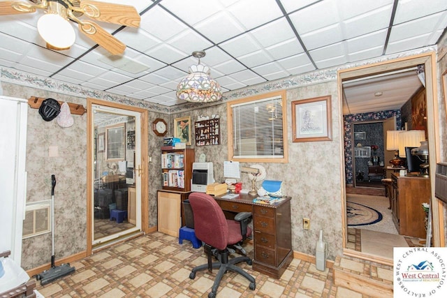 home office with light floors, baseboards, and wallpapered walls