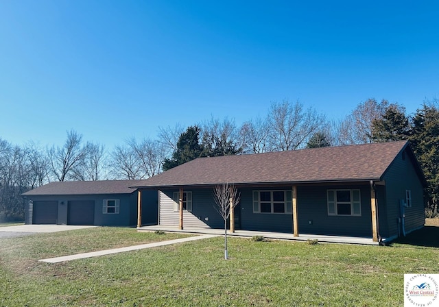 single story home with a garage, a front yard, and concrete driveway