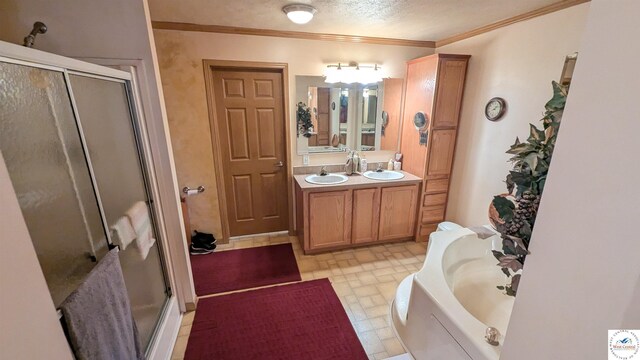 full bathroom with a textured ceiling, a sink, a shower stall, a bath, and double vanity