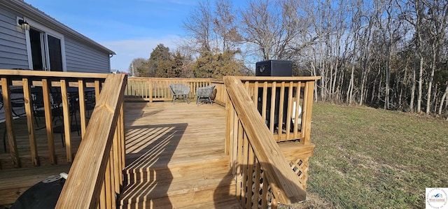 wooden deck featuring a lawn