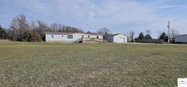 view of yard with a garage and a deck