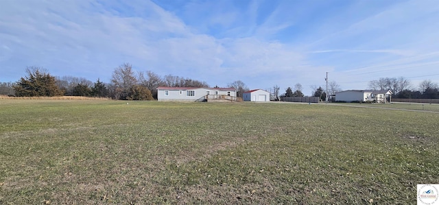 view of yard featuring a garage and an outdoor structure