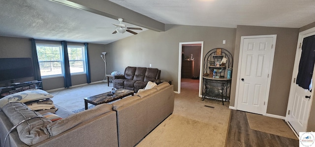 living room featuring light wood-style floors, vaulted ceiling with beams, baseboards, and ceiling fan