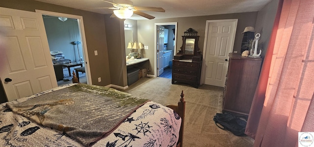 bedroom with a ceiling fan, light carpet, ensuite bath, and baseboards