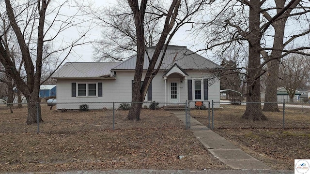 view of front of property with a fenced front yard and metal roof