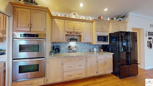 kitchen with light wood finished floors, tasteful backsplash, appliances with stainless steel finishes, light stone counters, and open shelves