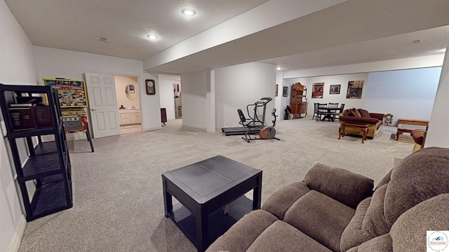 living area featuring recessed lighting, baseboards, a textured ceiling, and light colored carpet