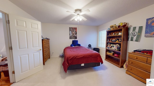 bedroom featuring a textured ceiling, carpet floors, and a ceiling fan