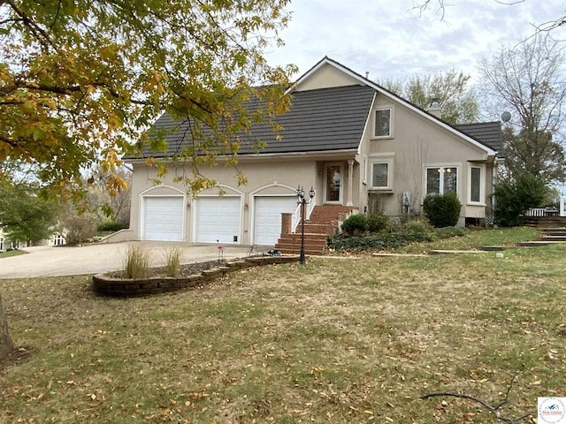 view of front of home with a garage, concrete driveway, a front yard, and stucco siding