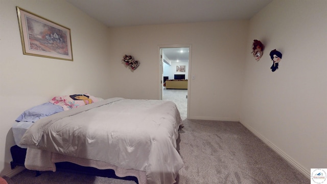 bedroom with baseboards and light colored carpet