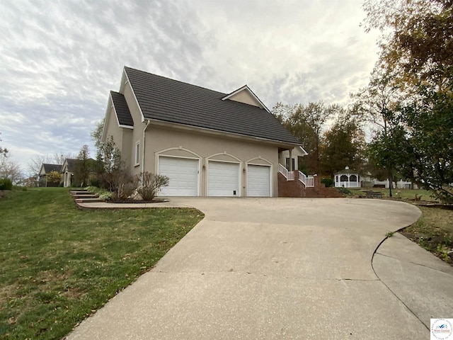 view of home's exterior featuring driveway, stucco siding, a garage, and a yard