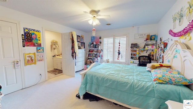 bedroom featuring ensuite bathroom, ceiling fan, and light colored carpet