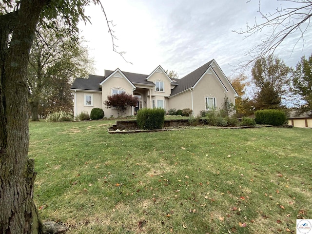 ranch-style home with stucco siding and a front yard