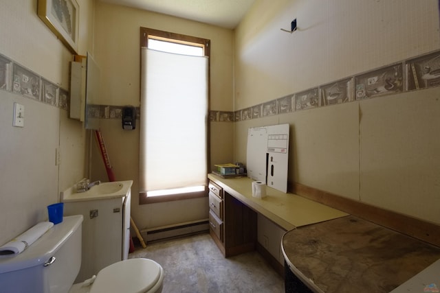 bathroom with baseboard heating, a sink, and toilet