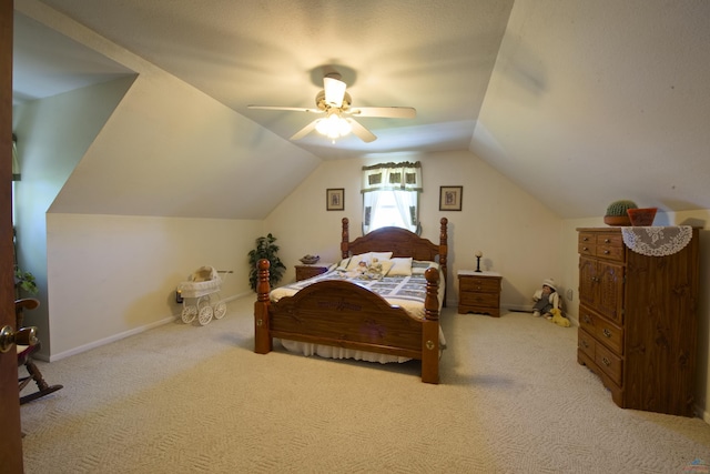 bedroom with vaulted ceiling, ceiling fan, baseboards, and light colored carpet