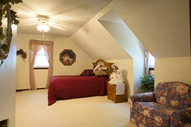 bedroom featuring lofted ceiling, ceiling fan, a textured ceiling, and light colored carpet