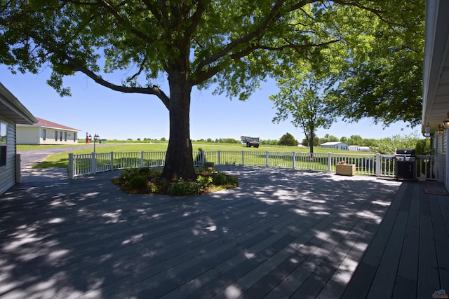 wooden terrace with a grill