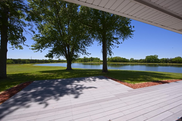 deck with a water view and a yard