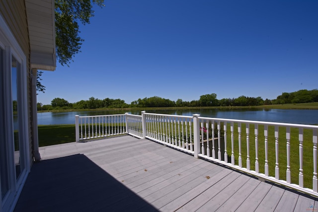 wooden deck featuring a water view and a yard