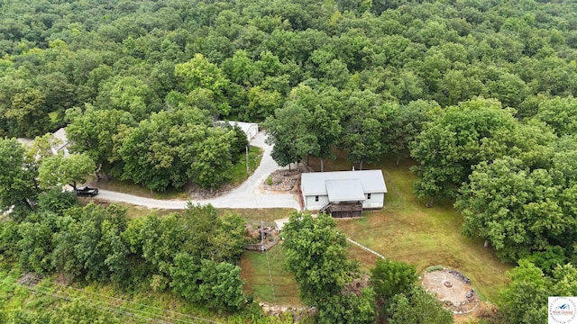 birds eye view of property with a view of trees