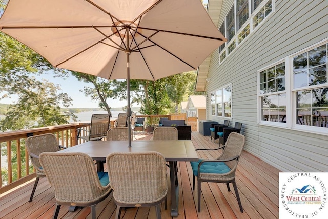 wooden terrace with outdoor dining area