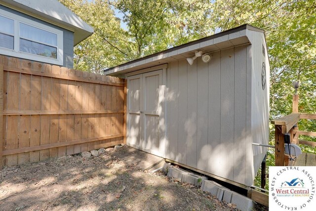 view of shed with fence