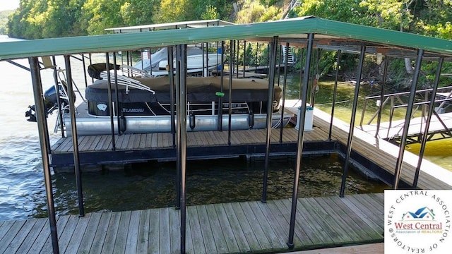 dock area with a water view and boat lift