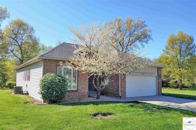 view of front facade with a garage, brick siding, concrete driveway, and a front yard