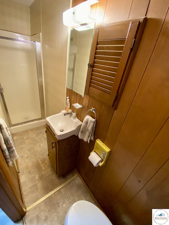 full bath featuring toilet, a shower stall, and vanity