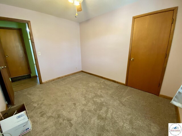 unfurnished bedroom featuring carpet and baseboards