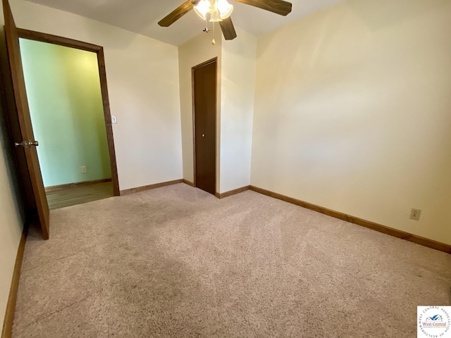 unfurnished bedroom featuring ceiling fan, baseboards, and carpet flooring