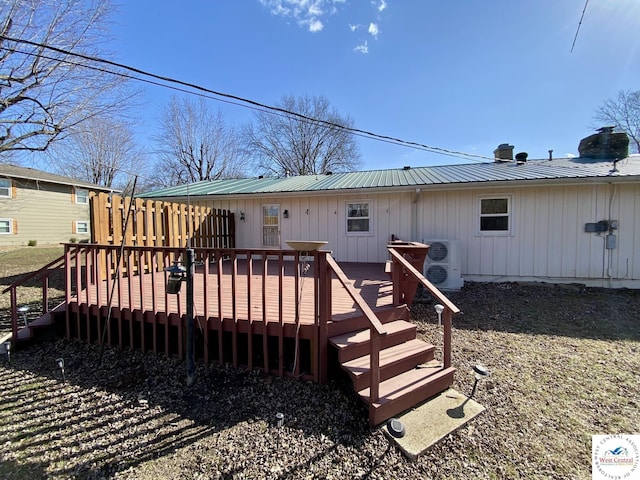 back of property with ac unit, metal roof, and a wooden deck