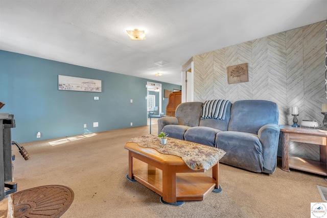 carpeted living room featuring an accent wall