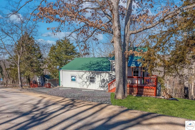 view of front of property with a front lawn and metal roof