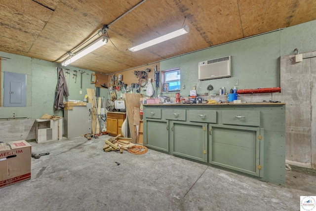 misc room with a workshop area, a wall unit AC, electric panel, and unfinished concrete floors