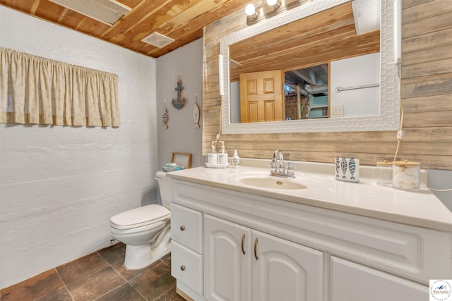 bathroom featuring visible vents, toilet, wood ceiling, stone tile flooring, and vanity