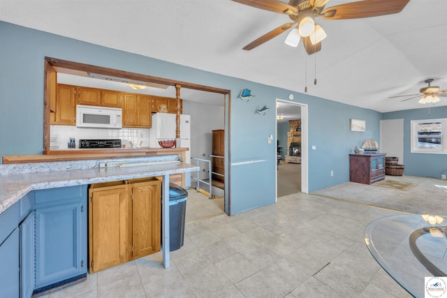 kitchen featuring white appliances, tasteful backsplash, open floor plan, and ceiling fan