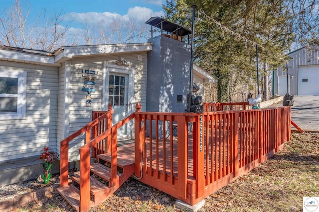 deck with a garage and an outdoor structure