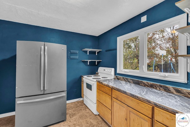 kitchen with freestanding refrigerator, white range with electric stovetop, dark countertops, and open shelves