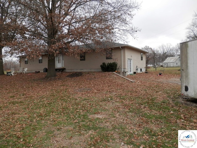 view of side of home with entry steps