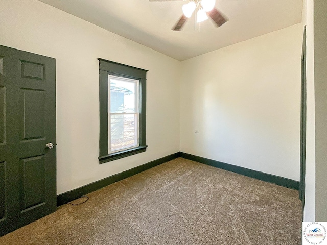 spare room with a ceiling fan, carpet flooring, and baseboards