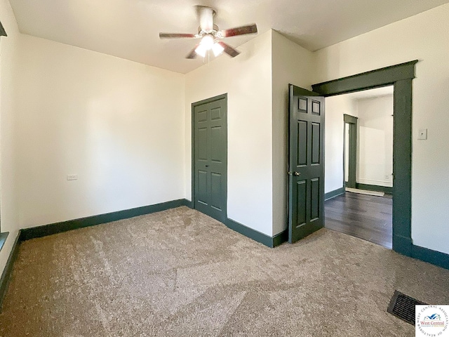 unfurnished bedroom featuring a ceiling fan, baseboards, visible vents, and carpet flooring