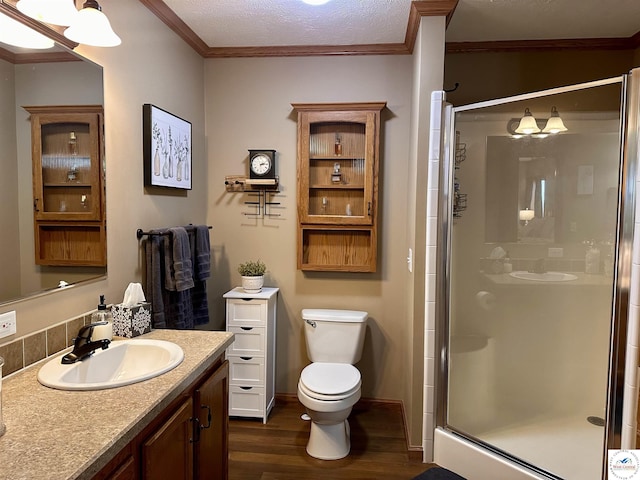 full bath with crown molding, a shower stall, toilet, and wood finished floors