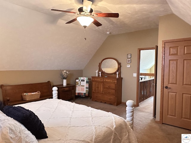 carpeted bedroom featuring ceiling fan, vaulted ceiling, and a textured ceiling