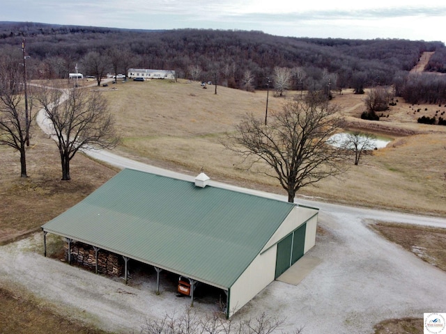 birds eye view of property with a wooded view