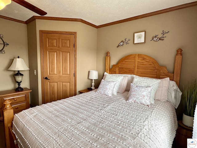 bedroom featuring ornamental molding, a textured ceiling, and a ceiling fan