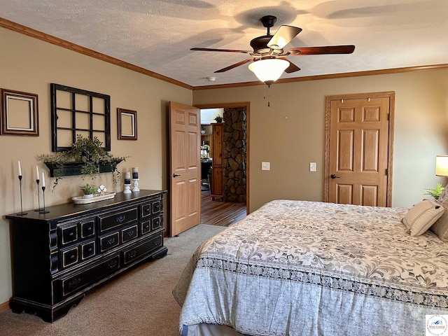 carpeted bedroom with crown molding, a textured ceiling, and ceiling fan