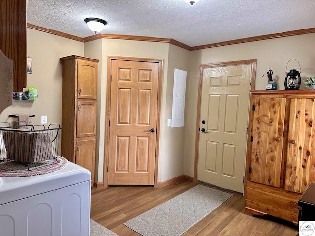 foyer entrance with light wood finished floors and ornamental molding